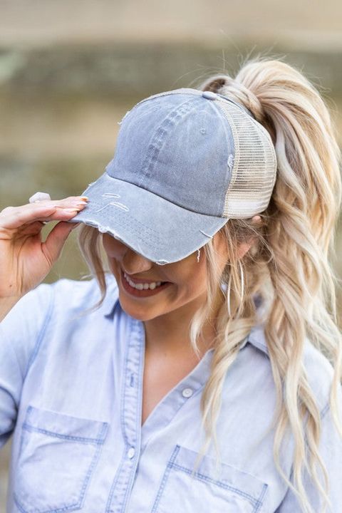 A denim cap paired with a volumetric high ponytail and with face framing hair are a classic idea