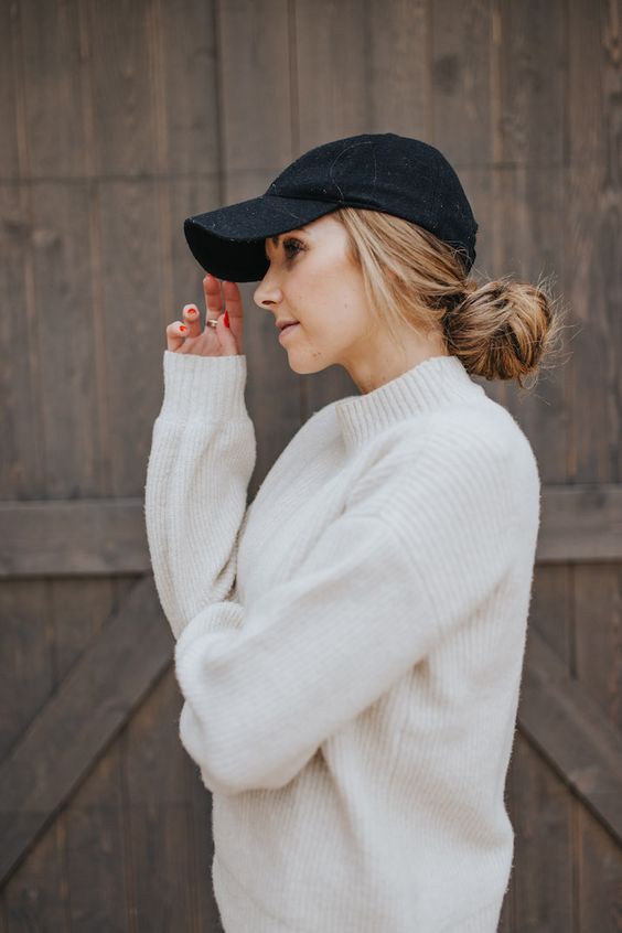 a large messy low bun and a black cap are a timeless combo for every day, comfortable and cool