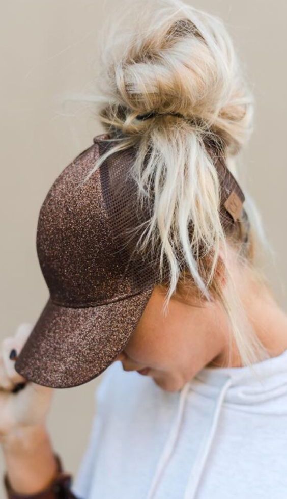 a messy volumetric top knot with a baseball cap are a cool combo for every day