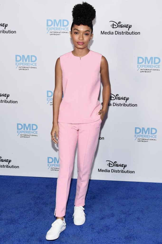 a pastel pink blouse and trouser set and white sneakers are ideal for spring