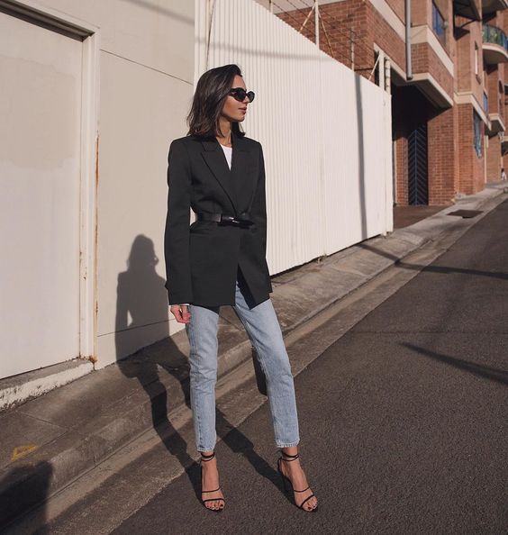 a white t-shirt, a black blazer with a black belt, blue jeans, black strappy shoes for an office look