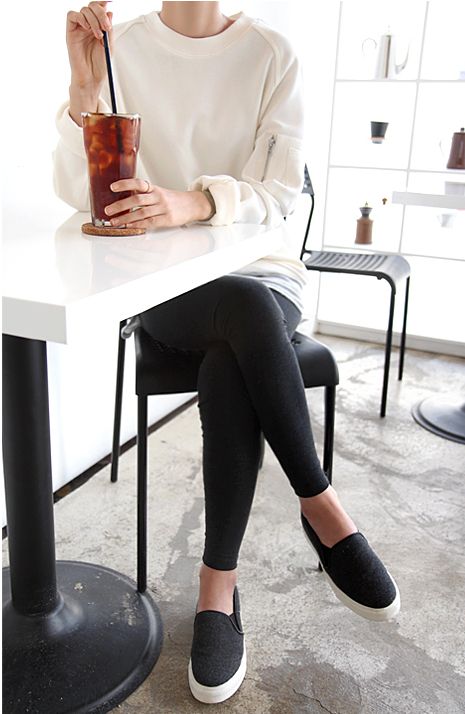 an oversized creamy sweatshirt, black leggings, black platform slipons for a simple everyday look