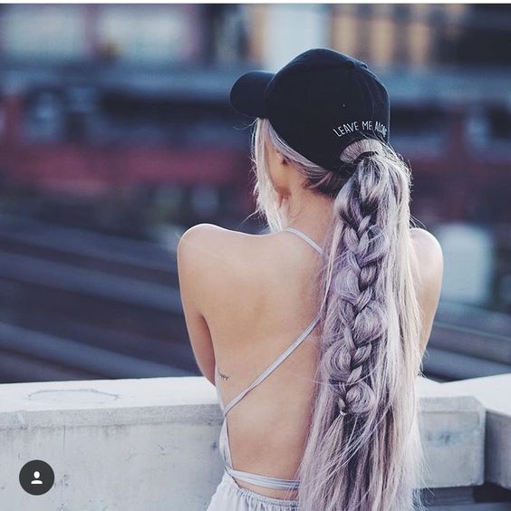beautiful long lavender hair into a ponytail with a messy braid, face-framing bangs and a black baseball cap