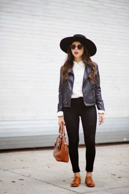 black skinnies, a white shirt, a black leather jacket, brown Derby shoes, a black hat and a brown bag