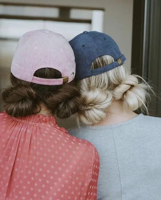 cute two low buns and baseball caps are a lovely idea for everyone with medium and long hair