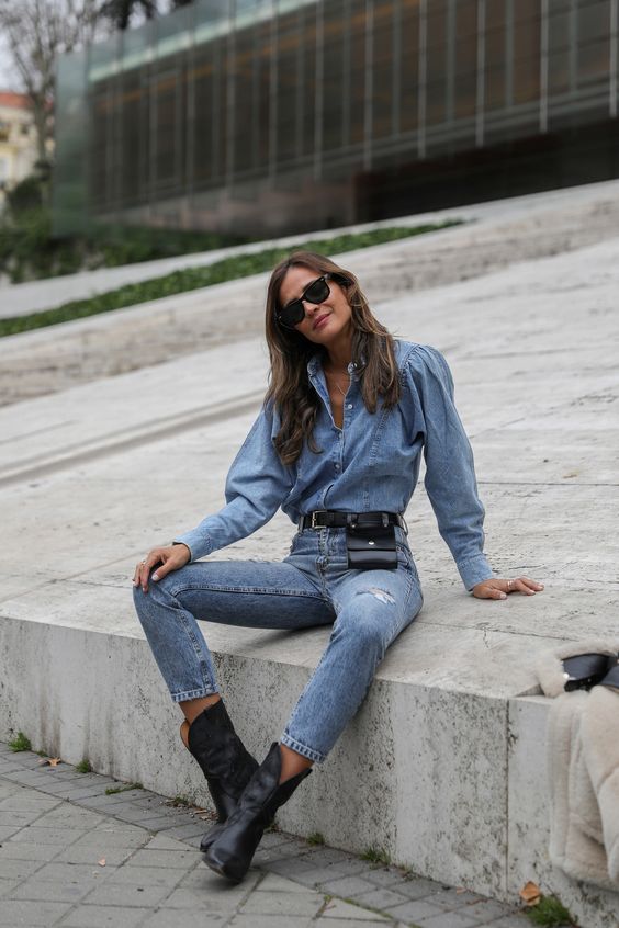 a total denim look with a chambray shirt with puff sleeves, high waisted skinnies, black cowboy boots and a waist bag