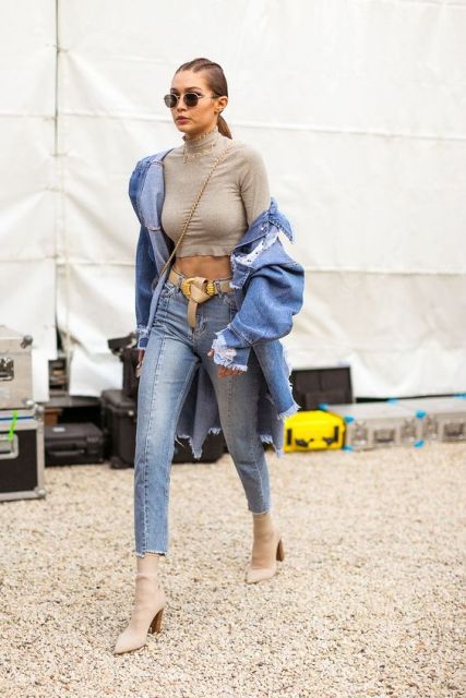 With beige crop turtleneck, denim jacket, chain strap bag and cropped jeans
