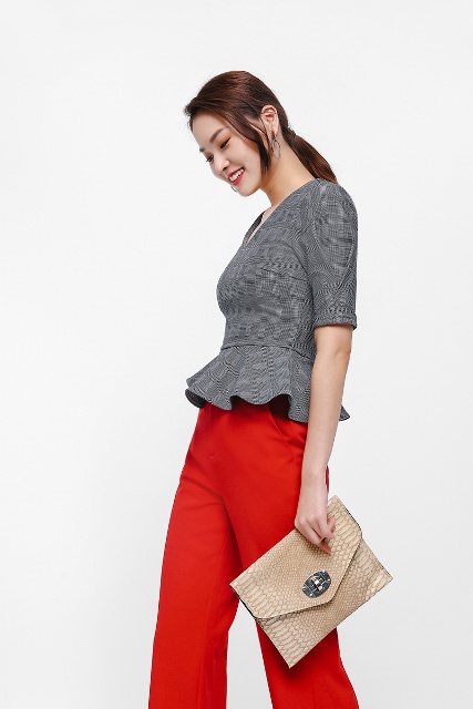 With red palazzo pants and beige leather clutch