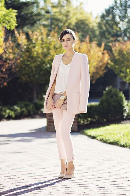 With white shirt, patent leather clutch and beige pumps