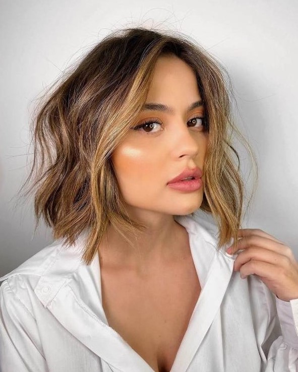 A beautiful brown bob with blonde balayage and face framing locks, with messy texture is a lovely idea