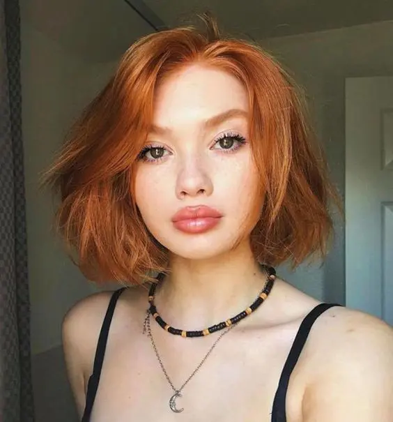 a beautiful ginger long bob with a lot of volume looks very eye-catching and very bright