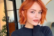 a bold copper red chin-length bob with a bit of waves is a stylish idea that will catch an eye with color