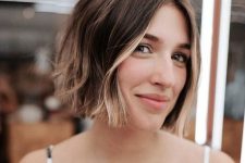 a brunette jaw-length bob with a bit of blonde balayage and money piece is lovely and bright