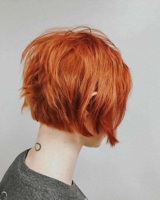a catchy and cool ear-length copper red bob with a lot of volume and some texture is a lovely solution