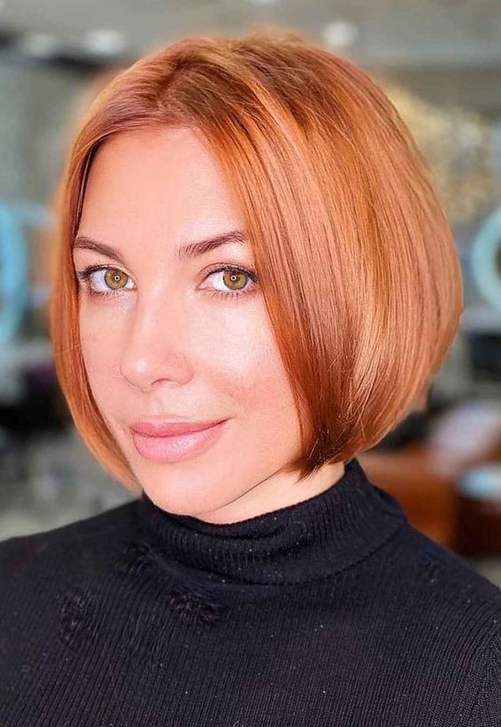 a classy sleek copper red jaw-length bob with a darker root and a bit of volume is a stunning idea