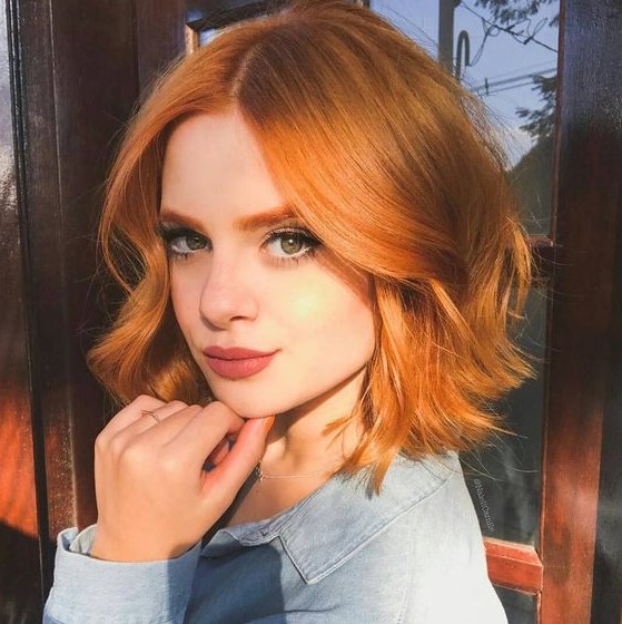 a cool copper red wavy long bob with face-framing layers looks really Instagram-worthy