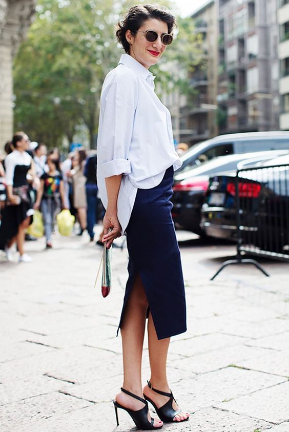 a fabulous office look with a blue oversized shirt, a navy pencil midi with a slit and black cutout shoes