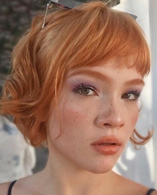 a ginger red jaw-length bob with layered bangs and waves is a catchy and fresh solution, and the color inspires