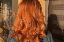 a lovely copper medium haircut with curled ends and a lot of volume looks amazing in the sun beams