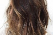 a shaggy brunette bob with face-framing bronde balayage to highlight the face