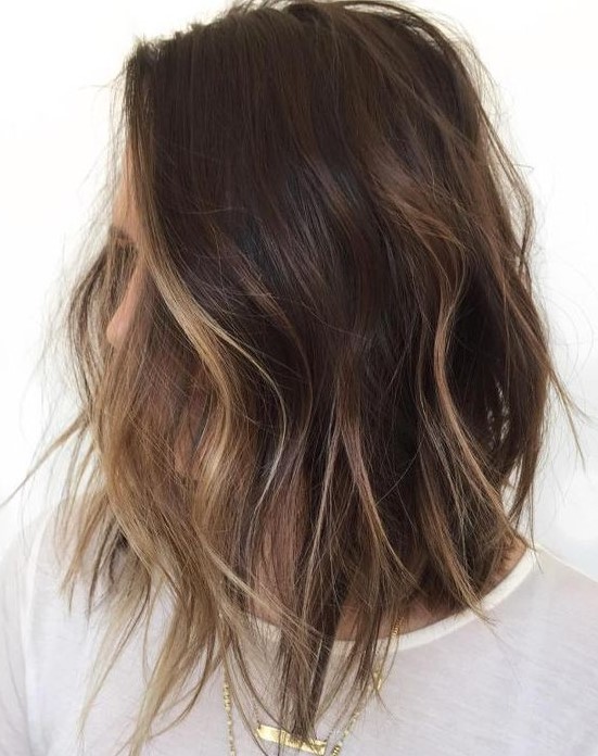a shaggy brunette bob with face-framing bronde balayage to highlight the face