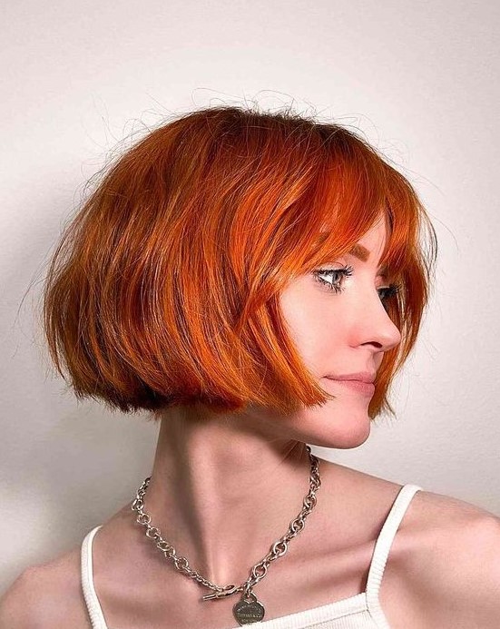 a stunning jaw-length bob with wispy bangs is a gorgeous idea to make a statement with color and shape