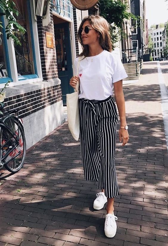 a white tee, black and white striped pants, white platform sneakers and a creamy tote