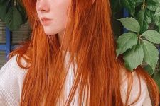 an elvish hairstyle with super long straight ginger hair with some volume is a jaw-dropping idea