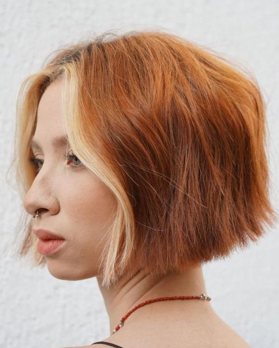 an eye-catching copper red wavy chin-length bob with a blonde money piece is a stylish and lovely idea