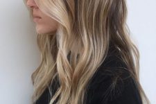 light brunette hair with sunkissed blonde higlights and with waves is a very actual and stylish idea