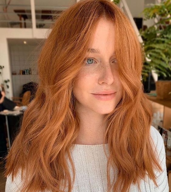 Long copper and ginger hair with a lot of volume and waves is a lovely idea, it looks very bright and eye catching
