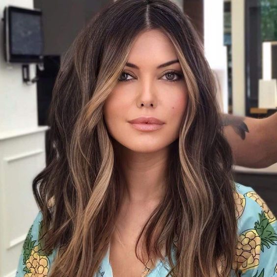 Long dark brunette hair with caramel face framing highlights to accent the face a little bit