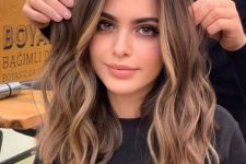 long dark brunette hair with caramel face-frmaing highlights and ombre touches plus waves looks wow