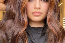 long dark brunette hair with copper face-framing highlights and a lot of volume is amazing