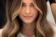 long dark brunette hair with golden blonde face-framing highlights and waves is a lovely and catchy idea