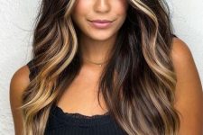 long dark brunette, lamost black hair with blonde face-framing highlights and balayage, volume and waves, is amazing
