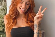 lovely long ginger hair with some waves is a cool and chic solution, it looks nice and very bold