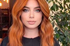 lovely medium-length ginger hair with a lot of volume and a bit of waves is cool and extra bold