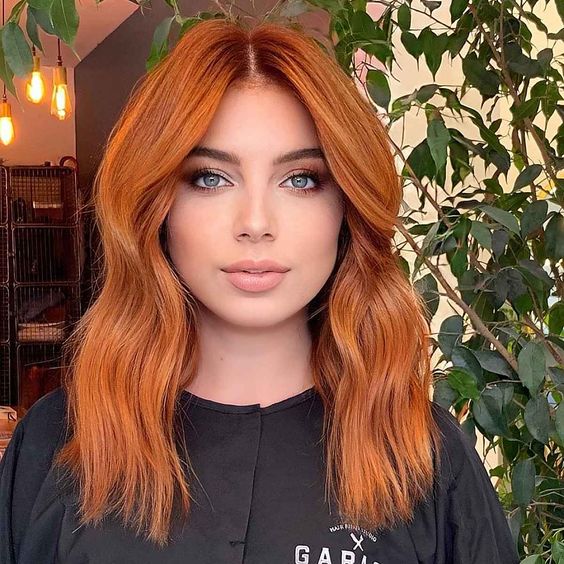 Lovely medium length ginger hair with a lot of volume and a bit of waves is cool and extra bold