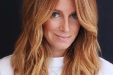 medium-length copper hair with ginger highlights and waves, with a bit of volume, is a catchy and cool idea