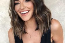 medium-length dark brunette hair with caramel balayage and face-framing highlights plus waves is a lovely idea