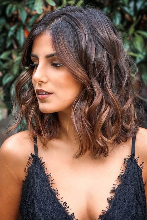medium length dark brunette hair with caramel balayage and waves looks amazing and very chic