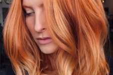 pretty copper medium-length hair with ginger and blonde highlights and a lot of volume is amazing