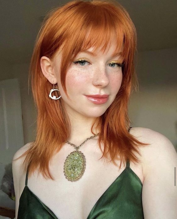 pretty medium-length ginger hair with wispy bangs and face-framing layers plus a bit of shag is amazing