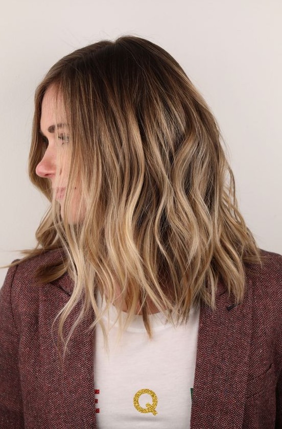 sunkissed blonde hair with a darker root and slight waves is a lovely idea for a summer and doesn't require maintenance