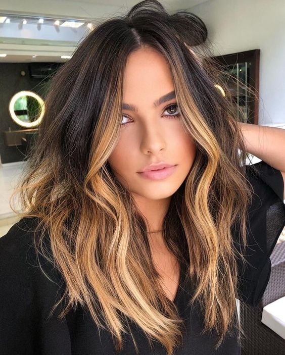 volumetric dark brunette hair with blonde highlights and ombre touches plus messy waves is a super cool idea
