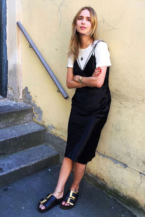 11 a monochromatic look with a white tee, a black slip midi dress with additional straps, black buckle sandals