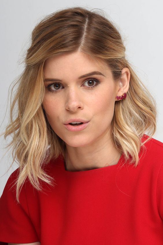 Kate Mara wearing medium-length golden blonde hair with darker roots and some messy waves looks super cute