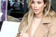 Kim Kardashian wearing long rooty blonde hair with a bit of texture looks fresh and casual chic