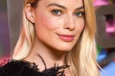 Margot Robbie wearing long rooty blonde hair with a bit of texture looks elegant and chic